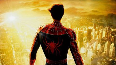 Detail from the Spider-Man 2 poster, with Peter Parker in Spider-Man costume, his mask off, back to the camera, facing out over a sunlit New York City