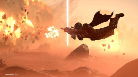 A Helldiver divers in front of a giant laser causing destruction in the background ahead of the Democratic Detonation Warbond release time.