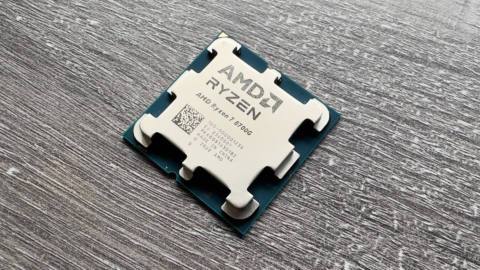 A photo of an AMD Ryzen 7 8700G APU on a grey desk