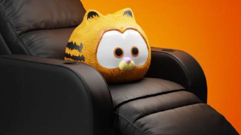 An image from Regal Cinemas’ official Twitter account purportedly showing an official Garfield Movie popcorn bucket, which looks like a big, brown leather recliner with a rendering of CG animated baby Garfield from the movie —&nbsp;essentially a limbless ball of orange fur with big cartoon eyes —&nbsp;sitting in the middle of it.