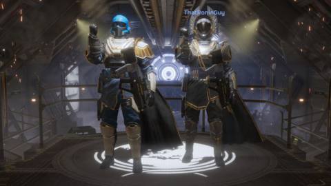 Two helldivers standing next to each other in Helldivers 2. They have small spotlights on them because they just had a great victory. They’re also wearing two different suits of armor.