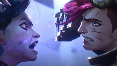 Vi and Jinx facing off in combat. Vi, with short pink hair and a snarl on her face, pulls back one augmented power fist to strike. Jinx, a younger woman with blue hair and smudge marks on her face, shouts defiantly.