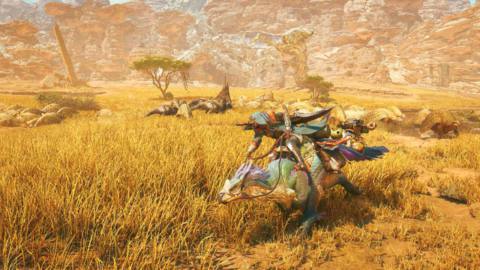 A hunter rides its steed, known as a Seikret, past a herd of dinosaur-like beasts roaming a desert plain in a screenshot from Monster Hunter Wilds