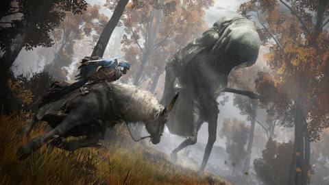 A Tarnished warrior rides on the back of the steed Torrent through the woods as they face a shrouded Wormface in a screenshot from Elden Ring