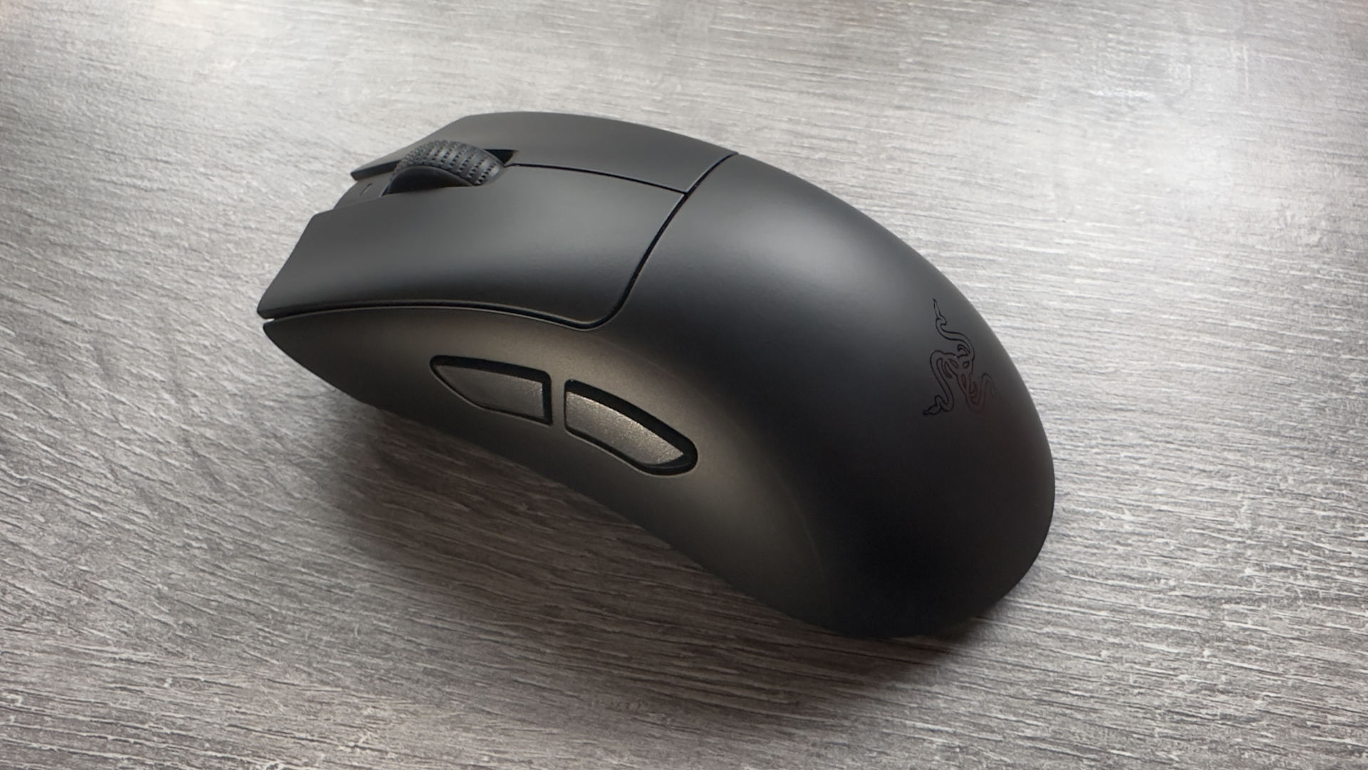 A photo of a Razer DeathAdder V3 HyperSpeed gaming mouse resting on an office desk