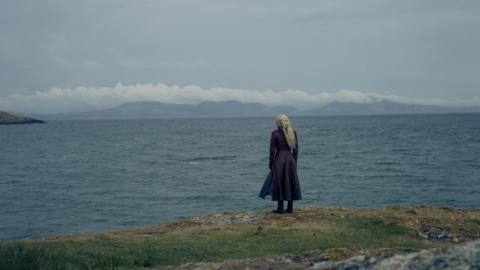 Rhaenyra standing on a cliff in a still from House of the Dragon season 2 episode 1