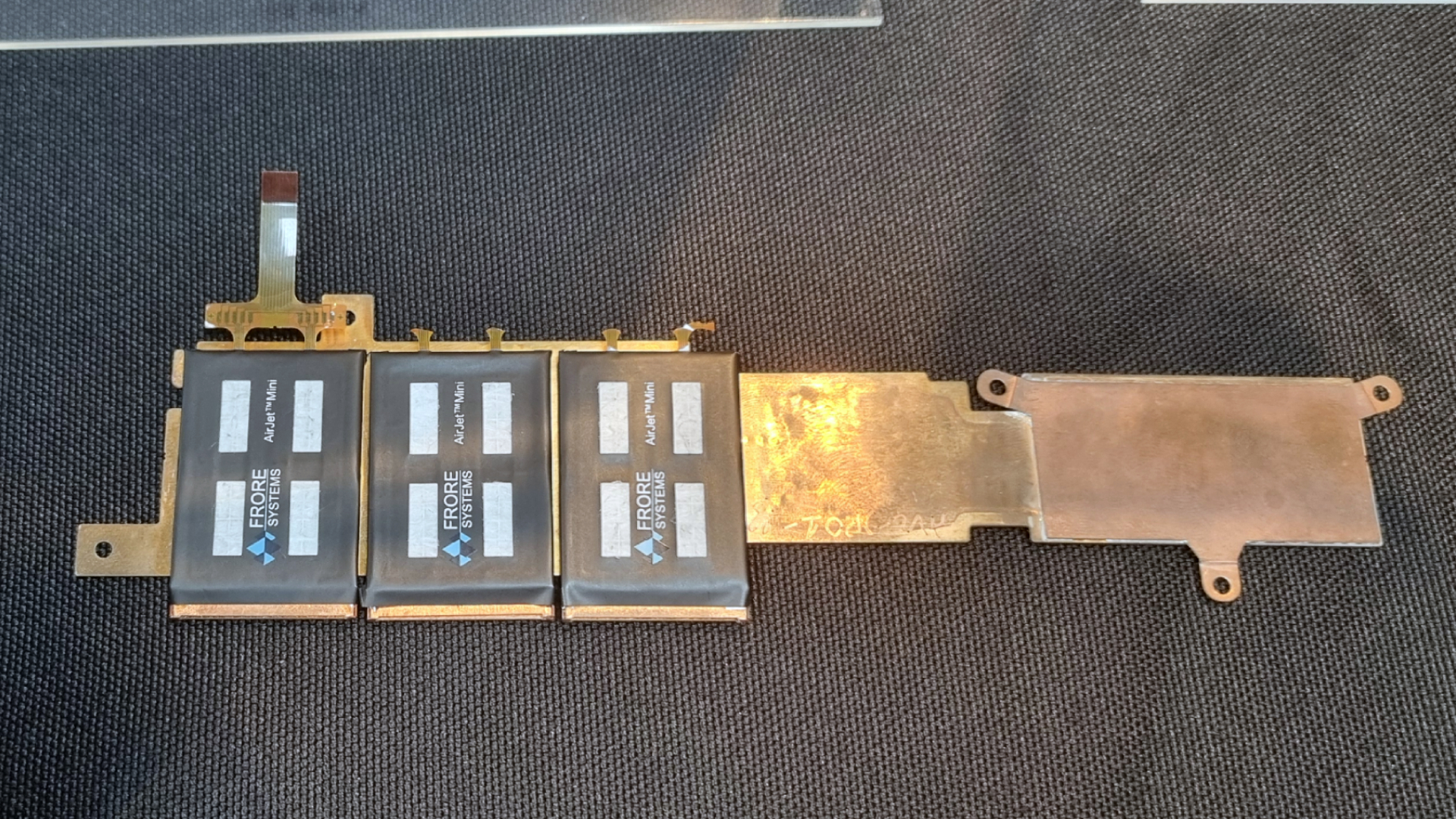 Three Frore AirJet Mini Slims attached to a copper cooling plate