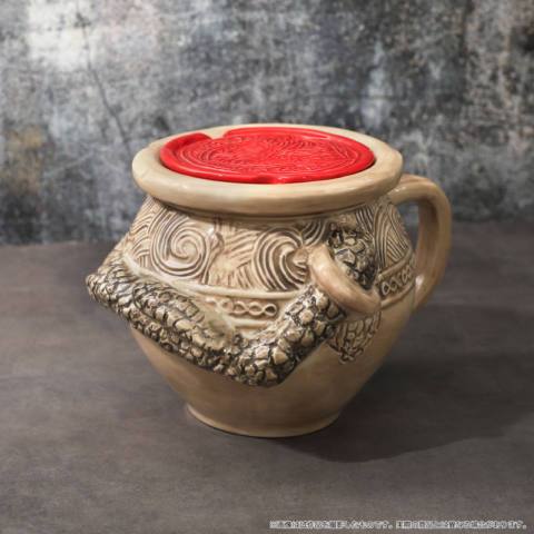 Images of real life Elden Ring tchotchkes, including a warrior jar mug, warrior jar piggy bank, and pin versions of Elden Ring talismans
