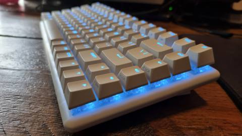 The Alienware Pro Wireless Gaming Keyboard, at an angle, lit up in blue