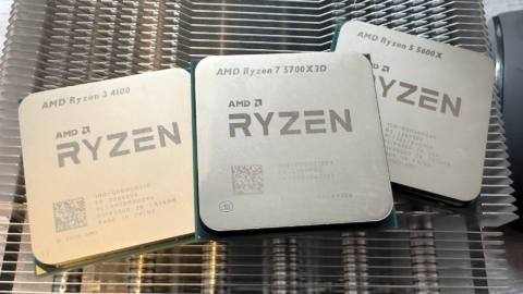 A photo of three AMD Ryzen processors resting on a metal heatsink