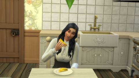 The Sim, Gabriella Duke, sitting at a table in her kitchen eating a grilled cheese sandwich.