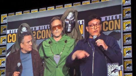 A photo of Joe and Anthony Russo flanking Robert Downey Jr. (who is wearing a crude Doctor Doom costume) from San Diego Comic-Con 2024