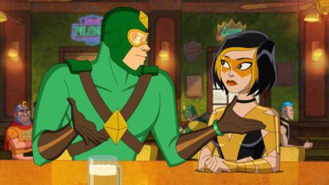 Kite Man and his girlfriend Golden Glider sit at a bar. He’s shrugging.