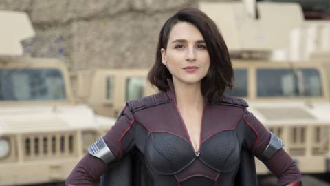 Aya Cash as Stormfront in front of a American flag