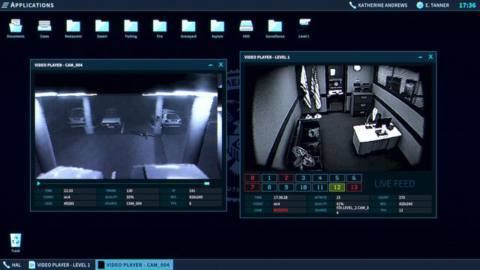 The player in The Operator examines two videos on their work station, one showing an office worker at a desk, and one showing a parking lot with a vehicle moving through.