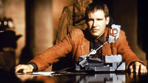 Harrison Ford sitting at a table in Blade Runner 