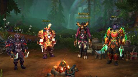 Four World of Warcraft characters of different races, in fine armor, stand around a campfire on the new Warband character select screen