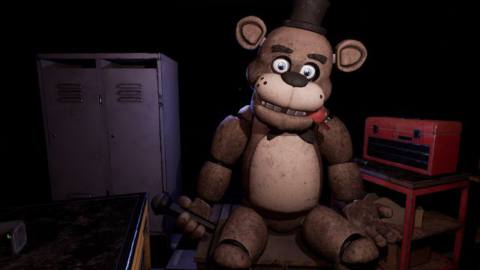Freddy Fazbear, an animatronic bear with an un settling presence, sits slumped and still in the back room of a pizzeria.