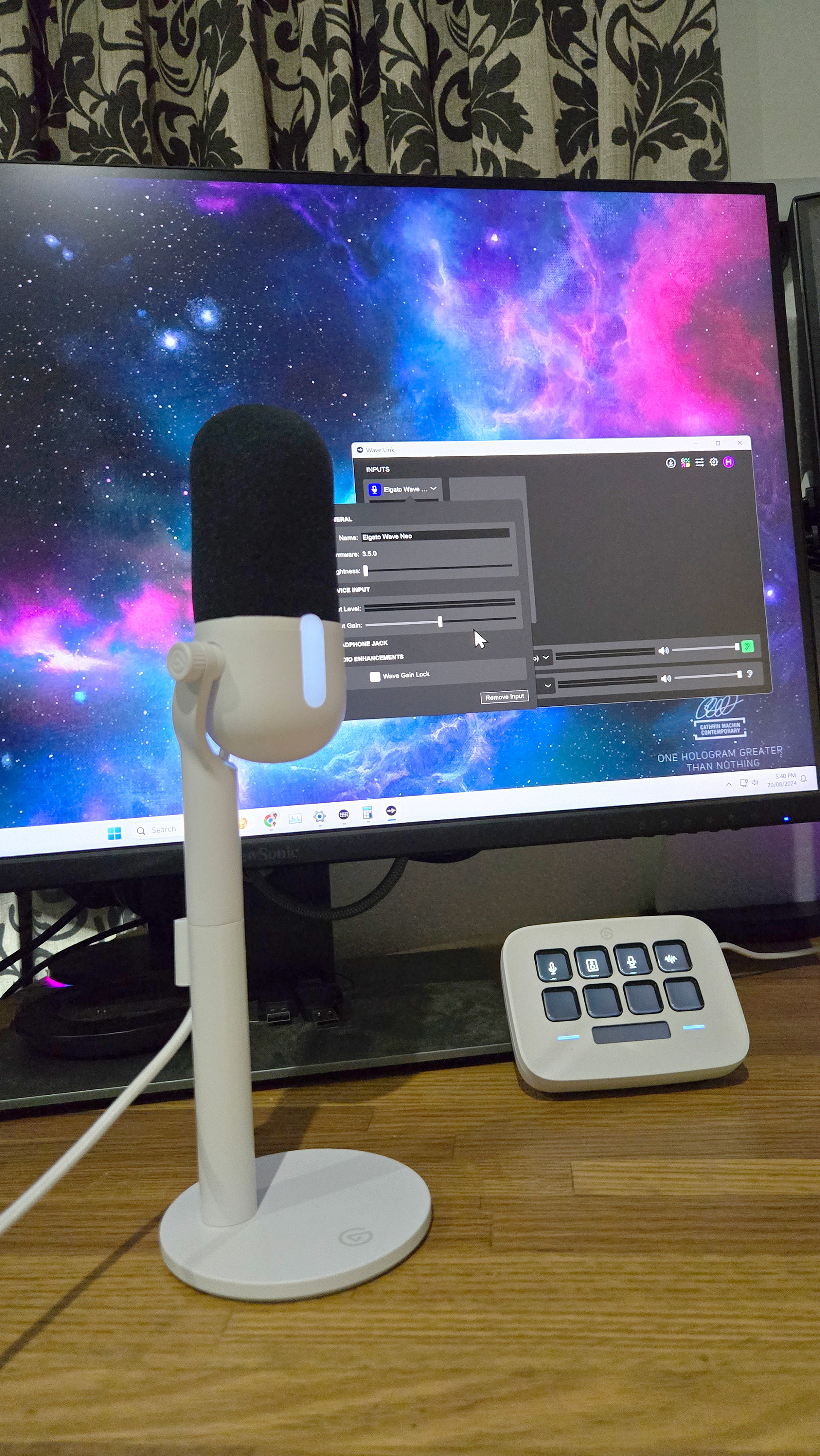 Elgato Wave Neo microphone set-up on a desk, with cables.