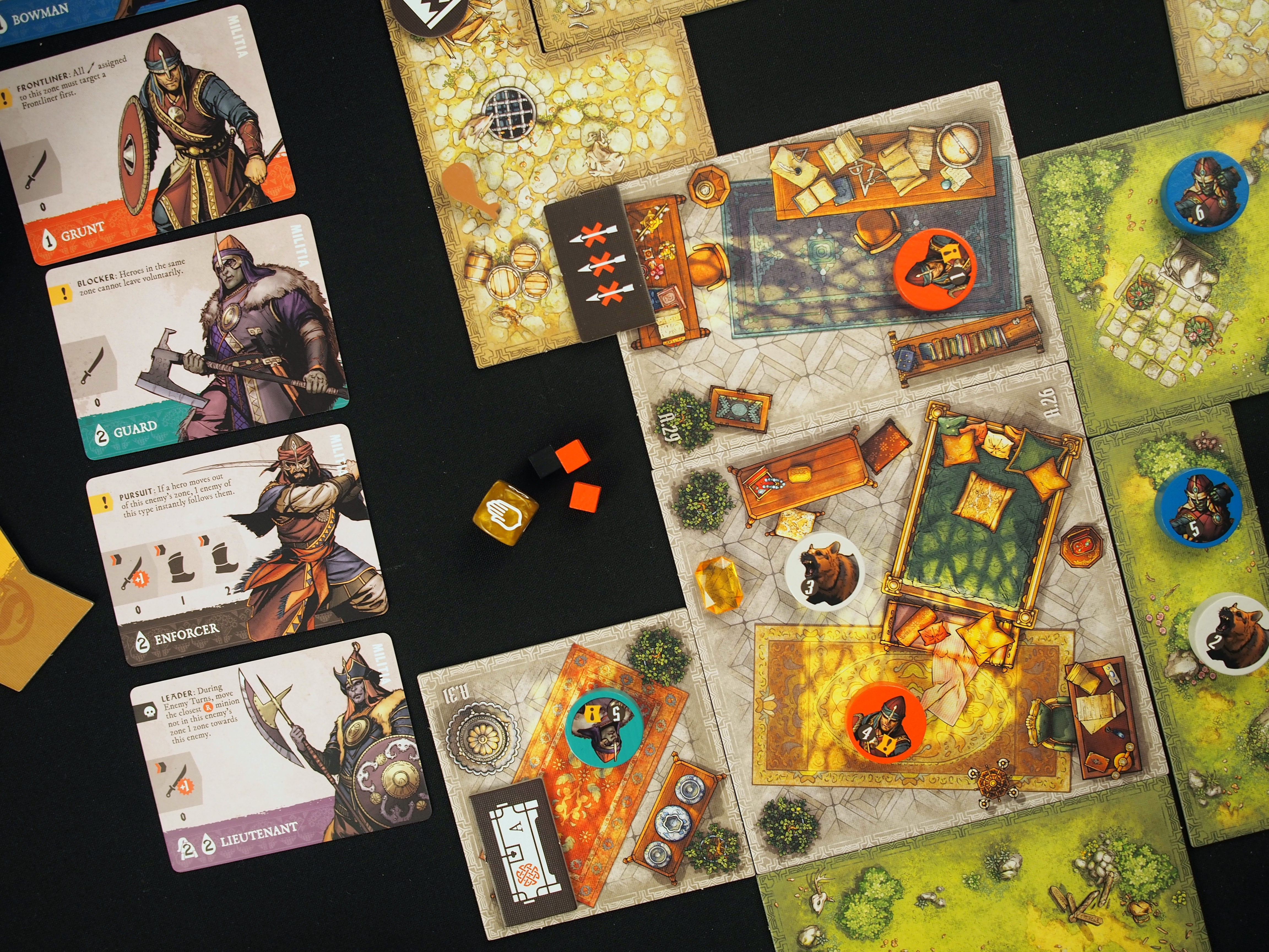 A map showing a bear enemy, two heroes, and a collection of cards to control the game’s enemies.