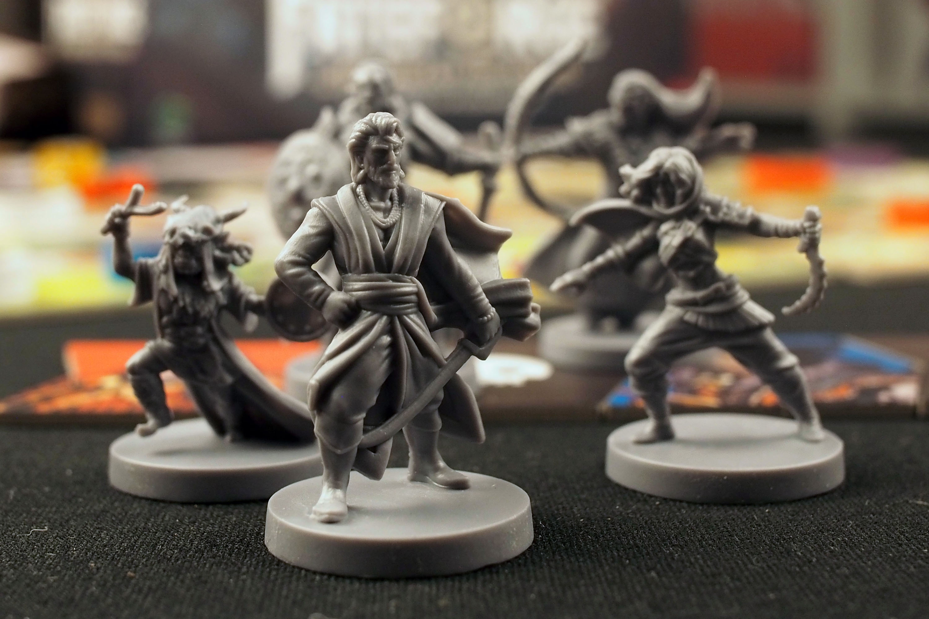 The miniatures for Fateforge include a swashbuckler with a saber, and a tiny creature with a kind of slingshot.