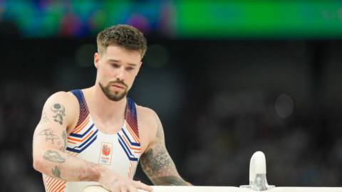 Casimir Schmidt competing in the Men’s Qualification during Day 1 of Artistic Gymnastics - Olympic Games Paris 2024 at Bercy Arena on July 27, 2024 in Paris, France. You can see the Mew and Toad tattoos on his right arm.