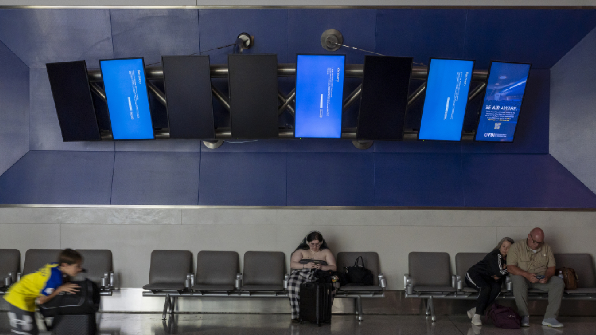 The Microsoft Corp. Windows Recovery screens displayed at George Bush Intercontinental Airport, in Houston, Texas, US, on Saturday, July 20, 2024. Airlines around the world experienced disruption on an unprecedented scale after a widespread global computer outage grounded planes and created chaos at airports. Photographer: David Paul Morris/Bloomberg via Getty Images