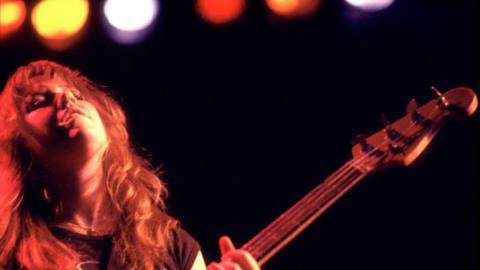 American musician Jackie Fox (born Jacqueline Fuchs), of the Runaways, playing bass guitar as she performs onstage at the Aragon Ballroom, Chicago, Illinois, March 25, 1977.