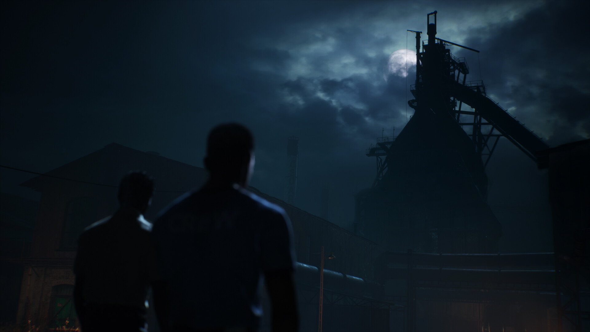 An ominous-looking steel mill, as seen at night, with a full moon in the background. Two figures are approaching the structure.