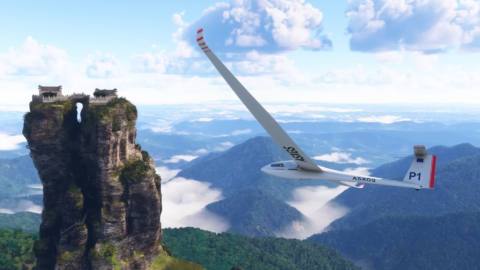 A glider soaring next to a mountain outcrop in MSFS 2024