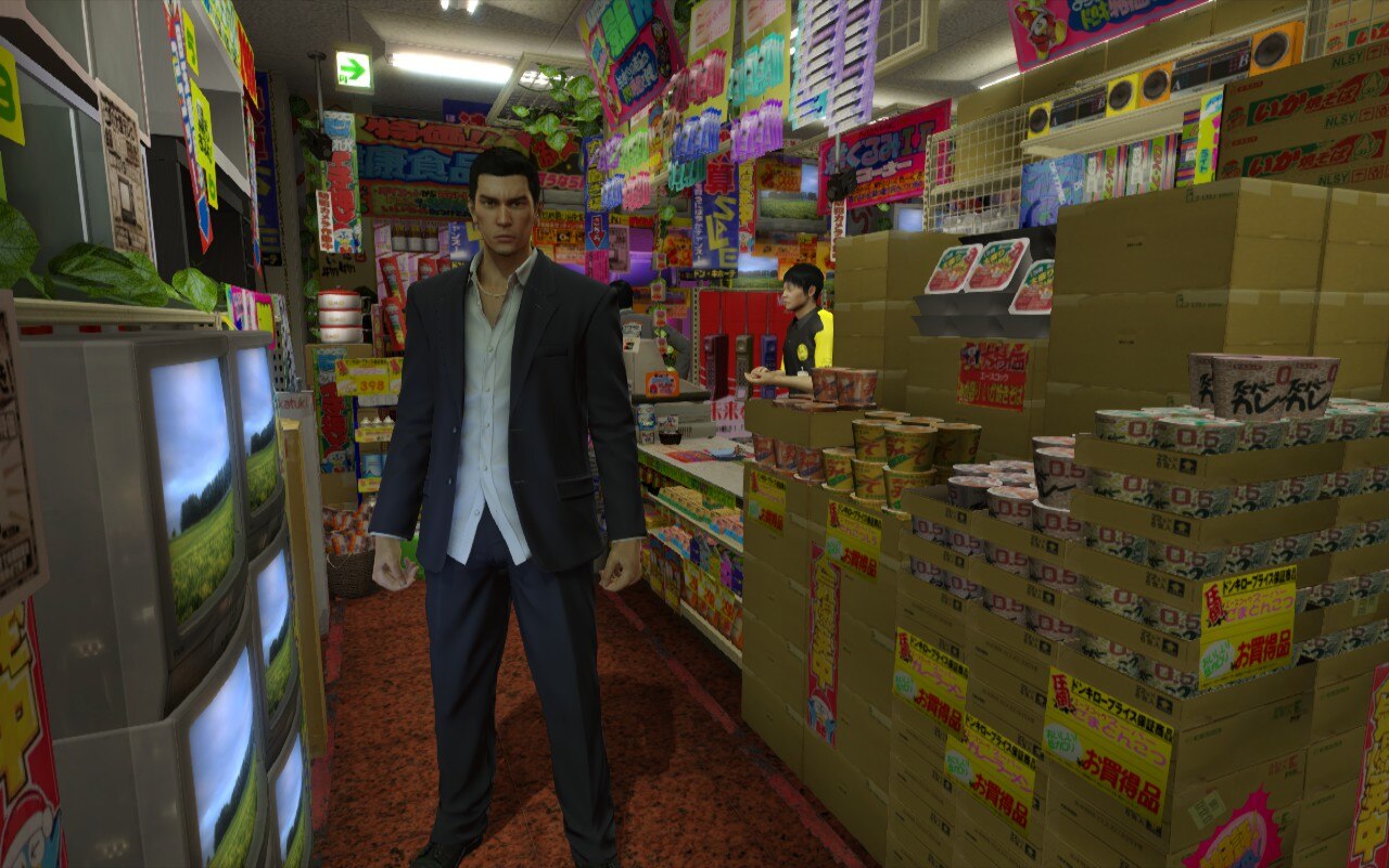 Kiryu stands in a store full of TVs and ramen containers in Yakuza 0. Kiryu stands in a store full of TVs and ramen containers in Yakuza 0.