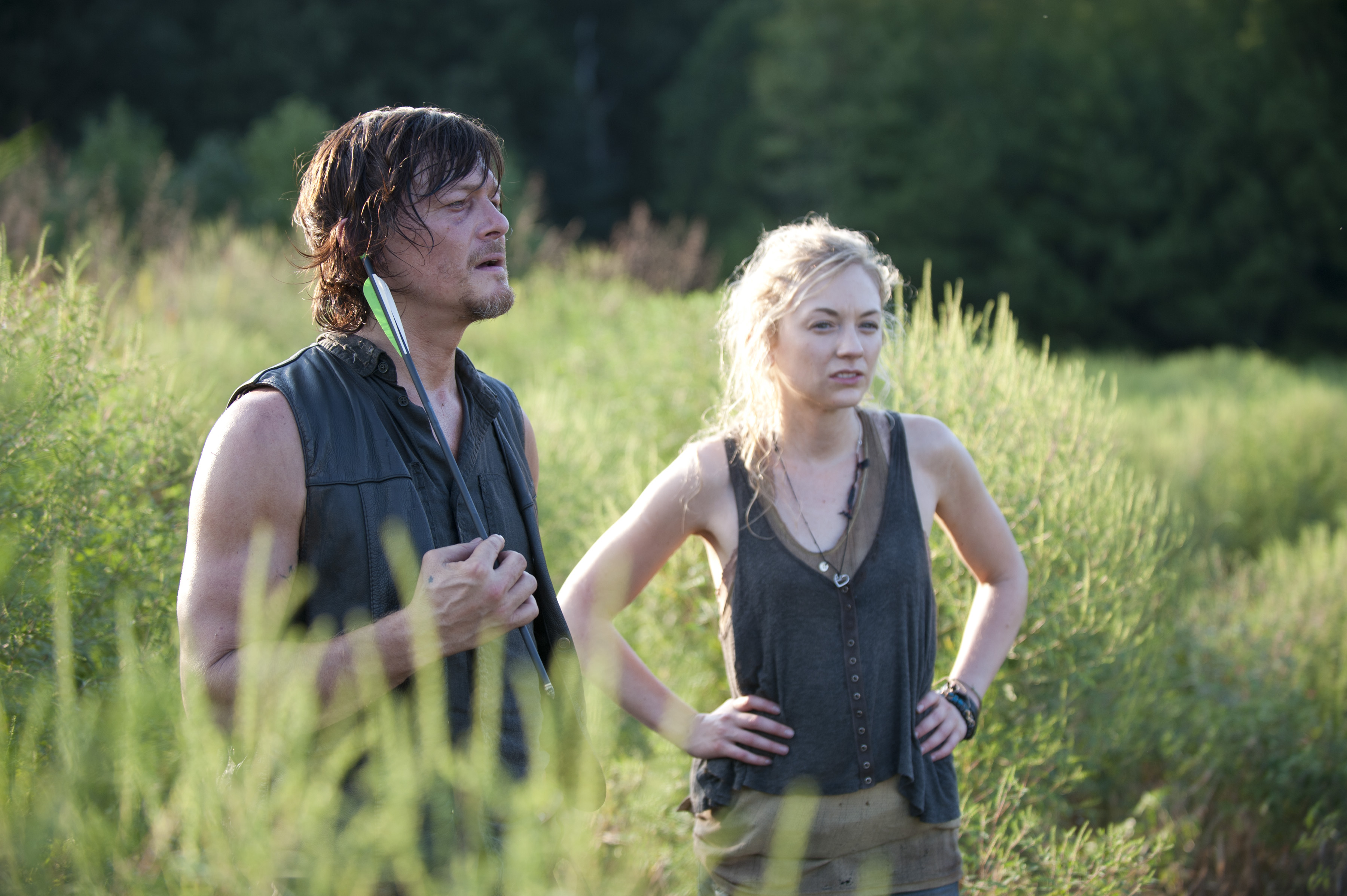 Daryl and Beth standing in a field