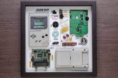 A stock photo of a framed, dissected Game Boy