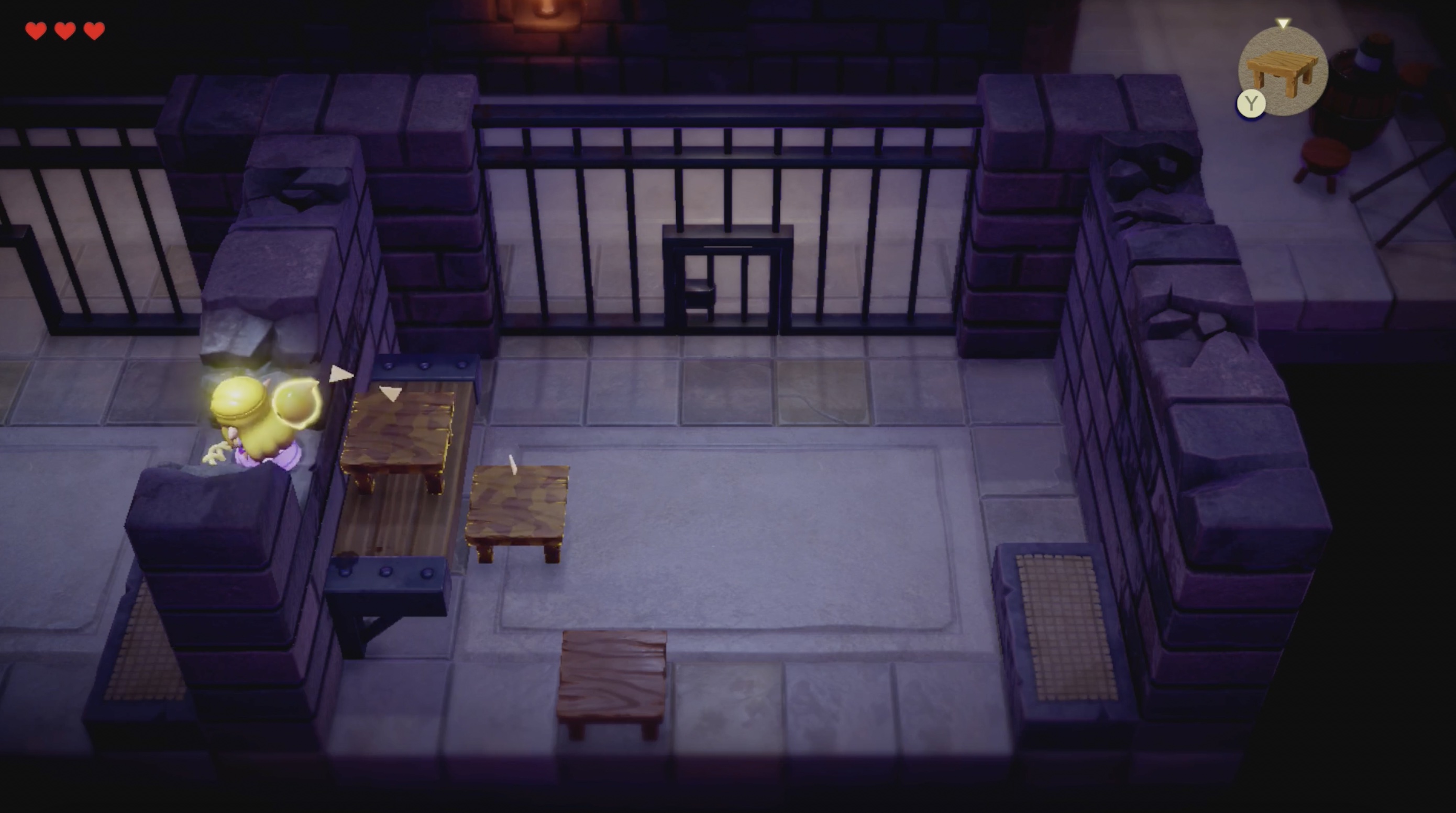 Zelda jumps through a hole in the wall in Hyrule Castle Jail in Echoes of Wisdom