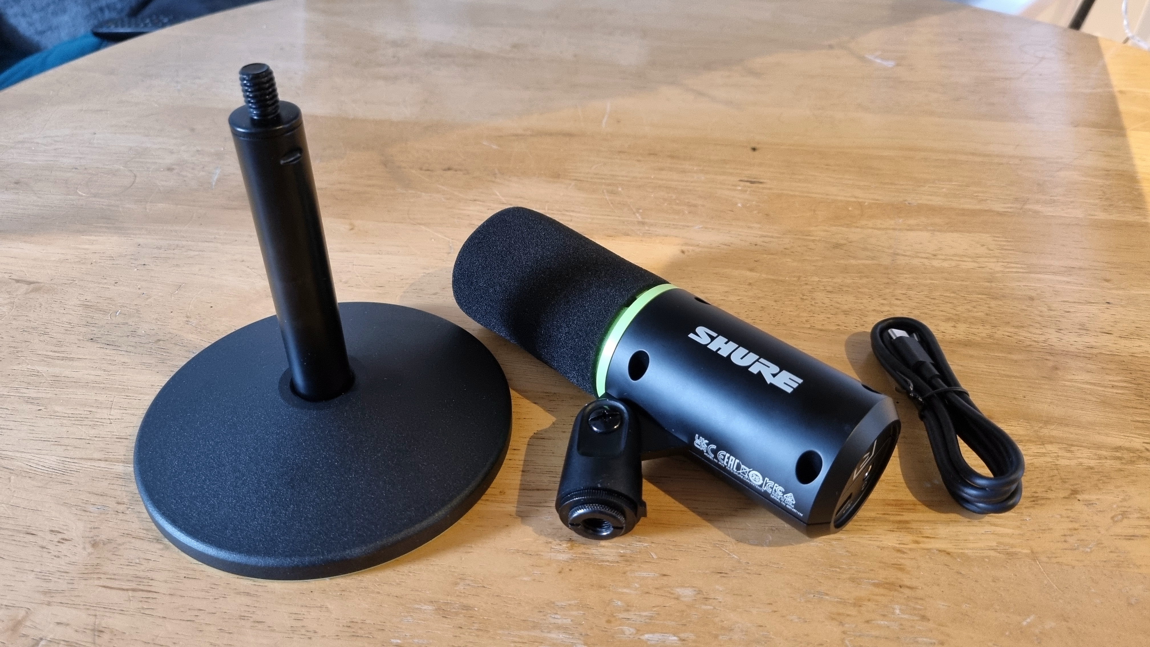 The Shure MV6 deconstructed, showing the base, the microphone in profile, and the capacitive mute button