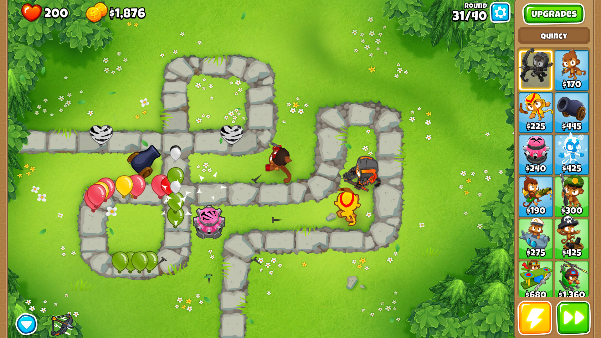 Several balloons travel down a stone path while monkeys with darts try to pop them