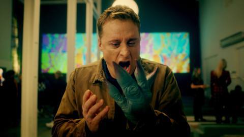 Alan Tudyk reacting to his alien hand in Resident Alien