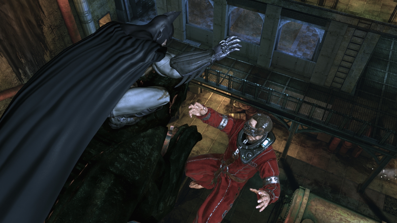 Batman grabbing a convict in Arkham Asylum