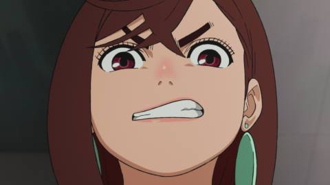 Momo, a teen girl wearing large earrings, makes a “grrrr” face in Dan Da Dan.