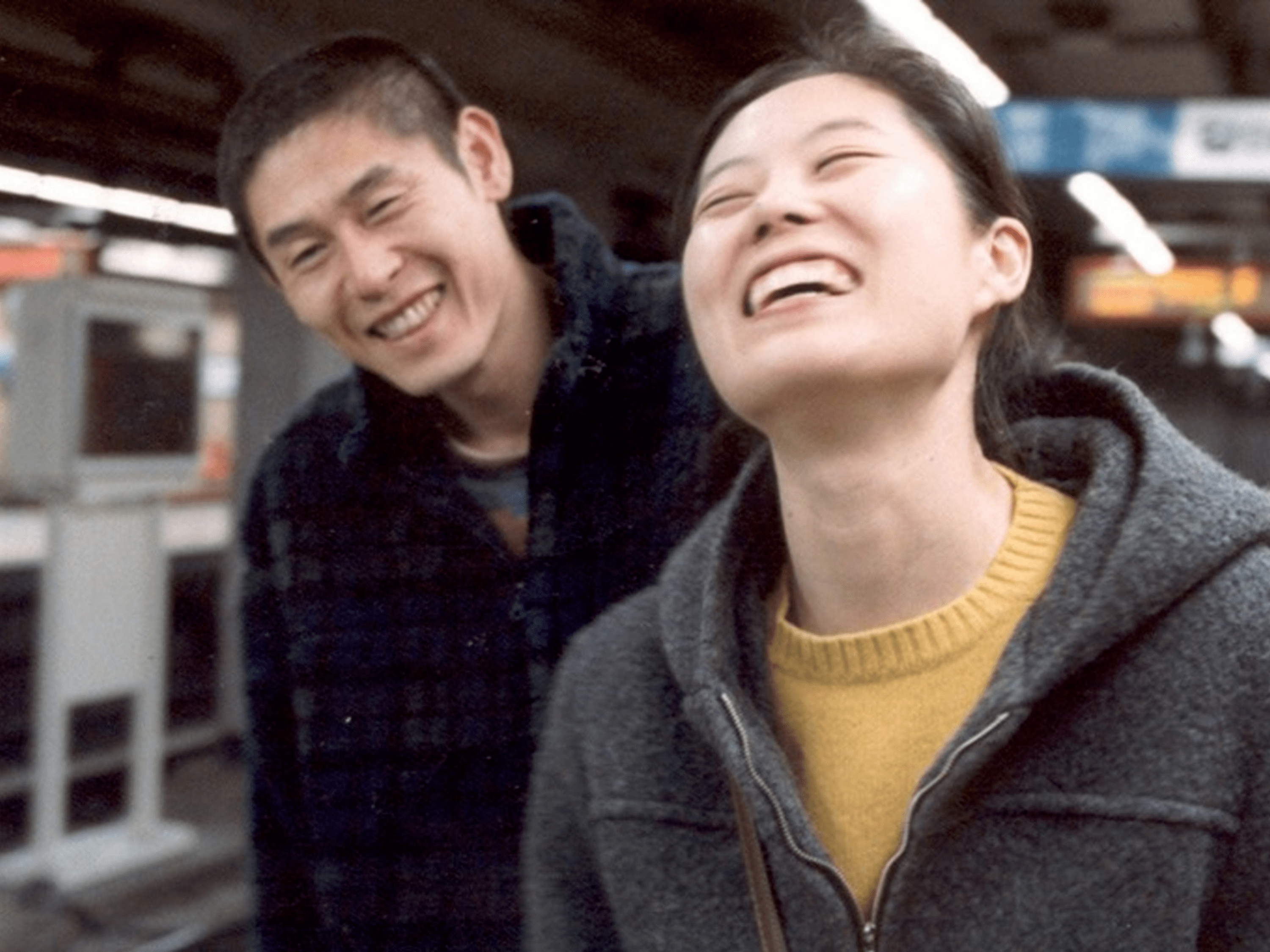 A man and a woman smiling at a subway station in Oasis.