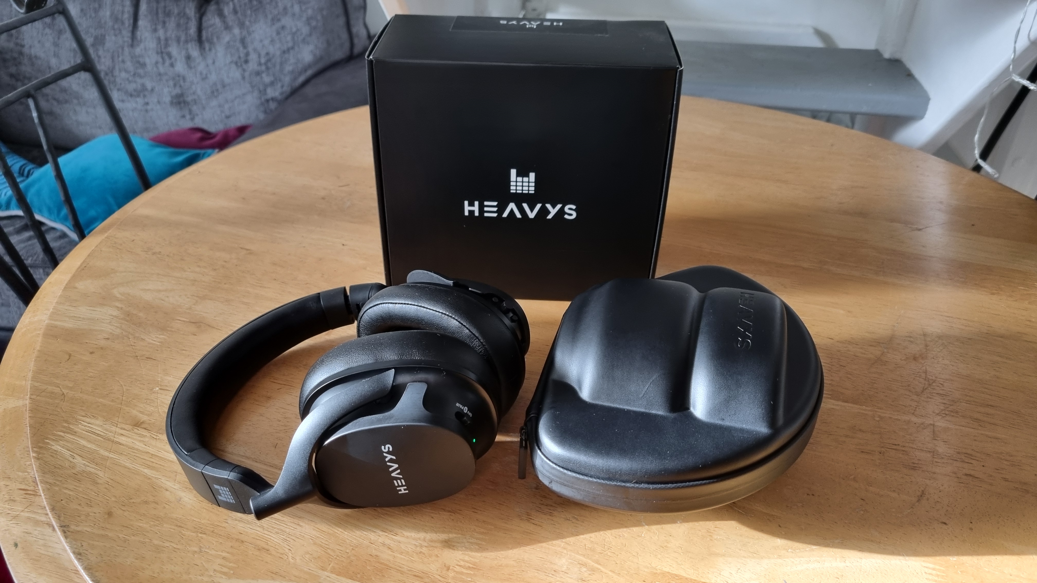 The Heavys H1H headphones, box, and included hard shell case.