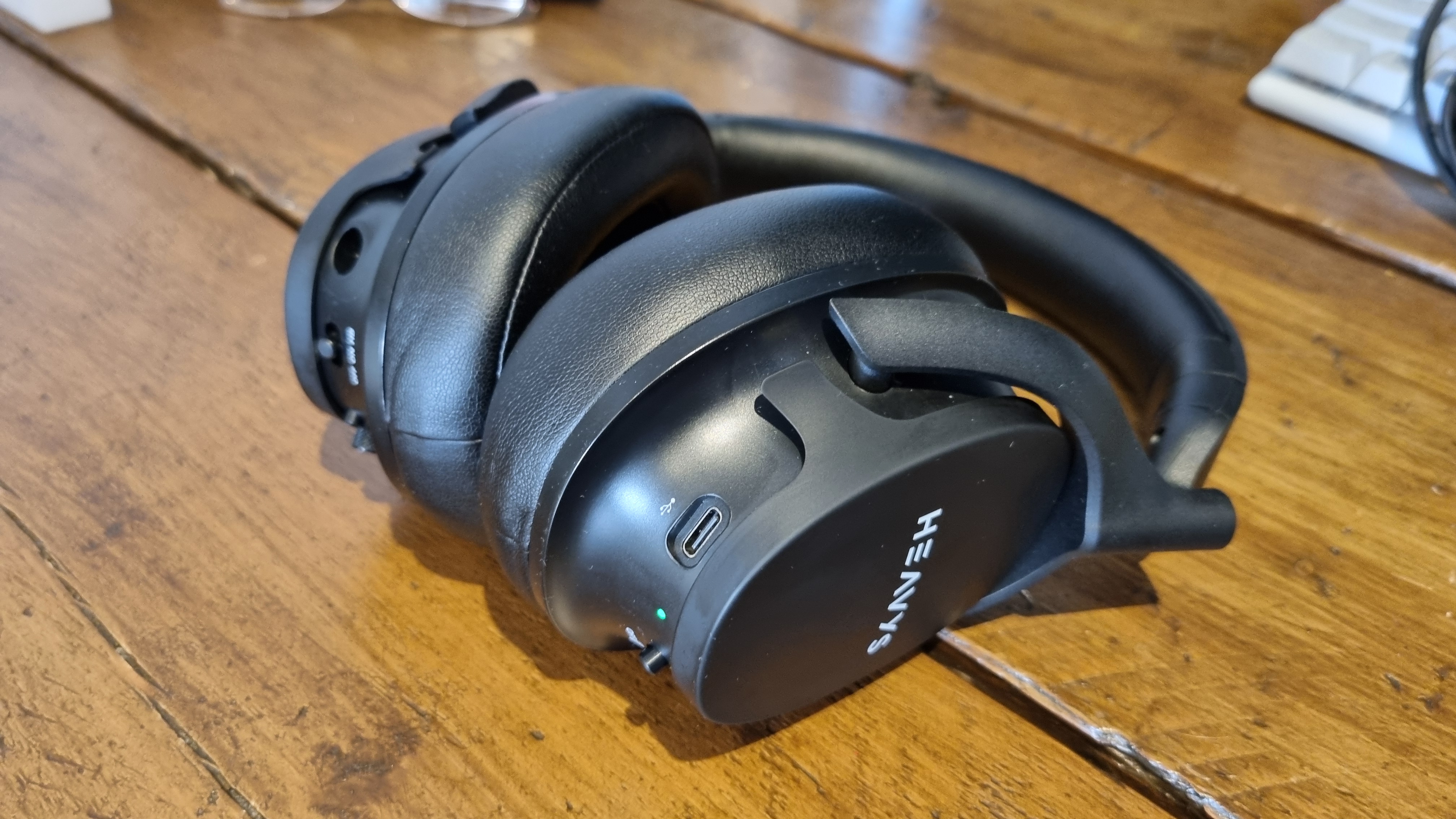 The Heavys H1H headphones, sitting on a wooden desk