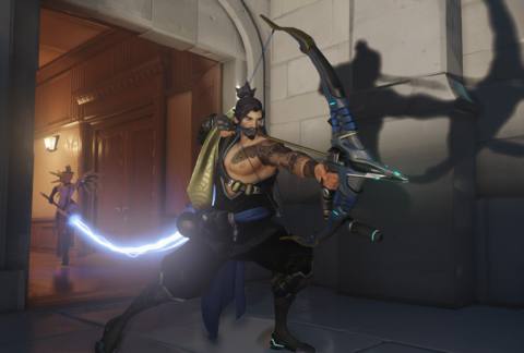 An Overwatch screenshot shows Hanzo about to shoot an arrow with his giant shadow showing on the wall behind him