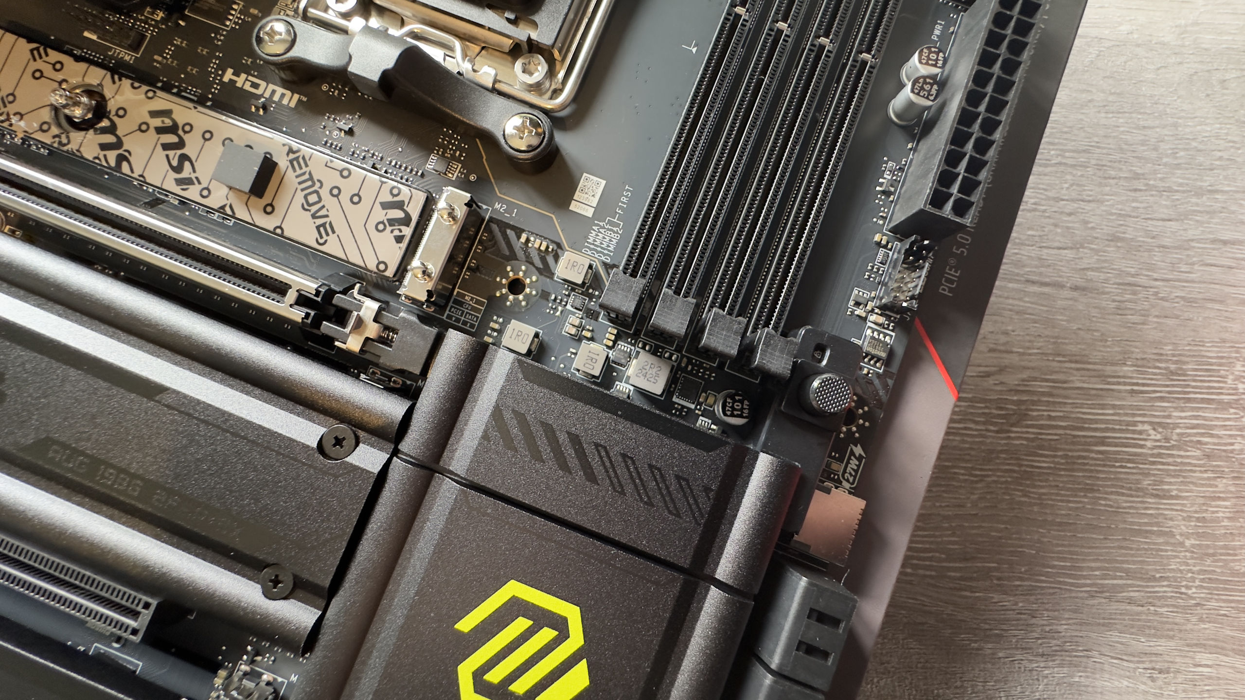 A photo showing the GPU retaining mechanism on an MSI MAG X870 Tomahawk motherboard