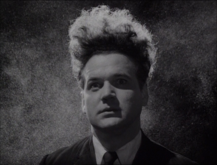 Jack Nance as Henry Spencer, a man with long flowing hair in Eraserhead.