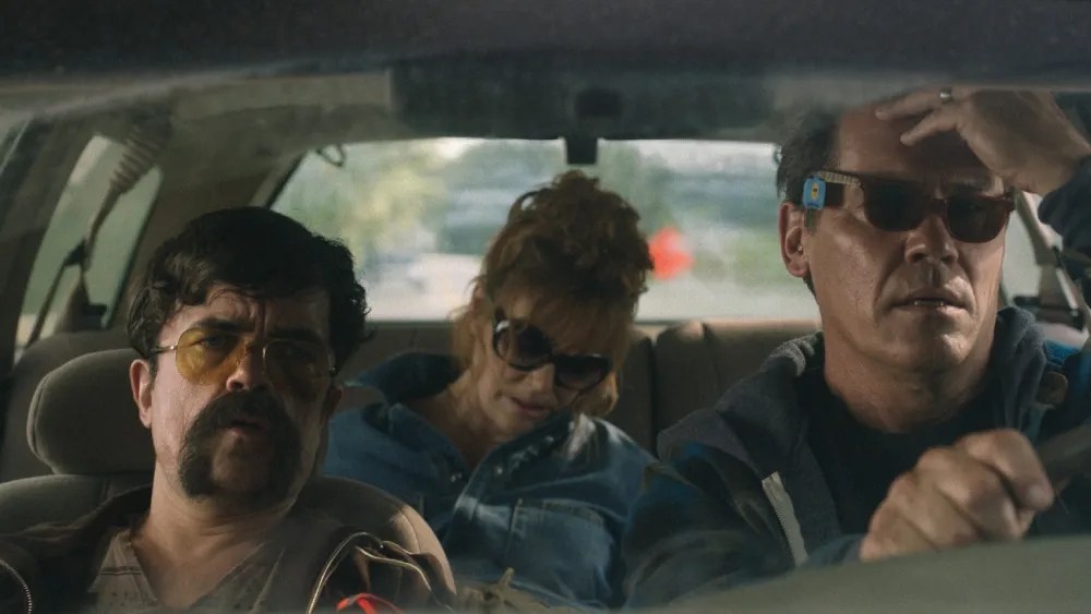 Peter Dinklage and Josh Brolin driving a car and wearing sunglasses in Brothers.