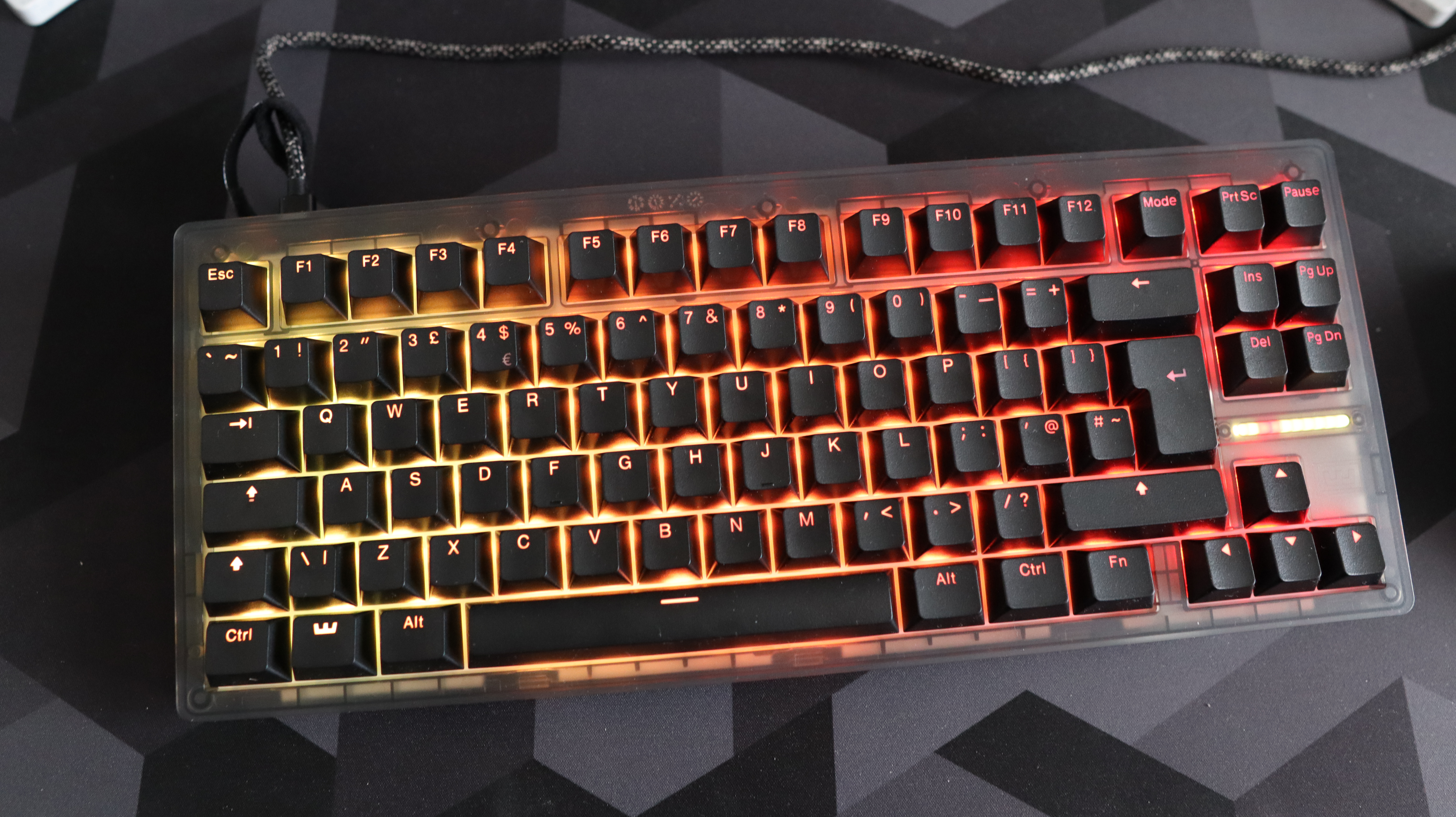 The Wooting 8-HE on a mouse pad with RGB lighting enabled.