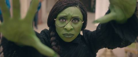 Cynthia Erivo as Elphaba using her hand magic in Wicked. Her skin is green.