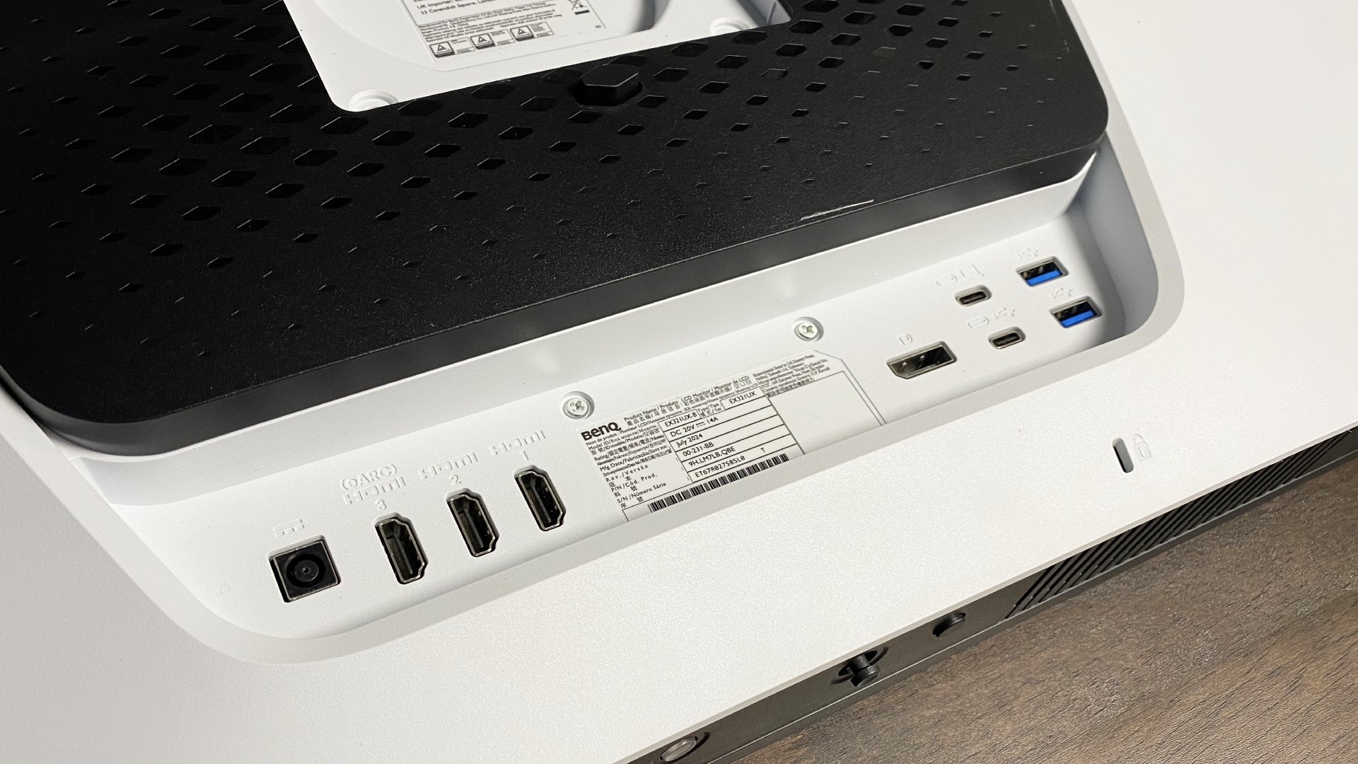 A close-up photo of a BenQ MOBIUZ EX321UX gaming monitor's input/output ports