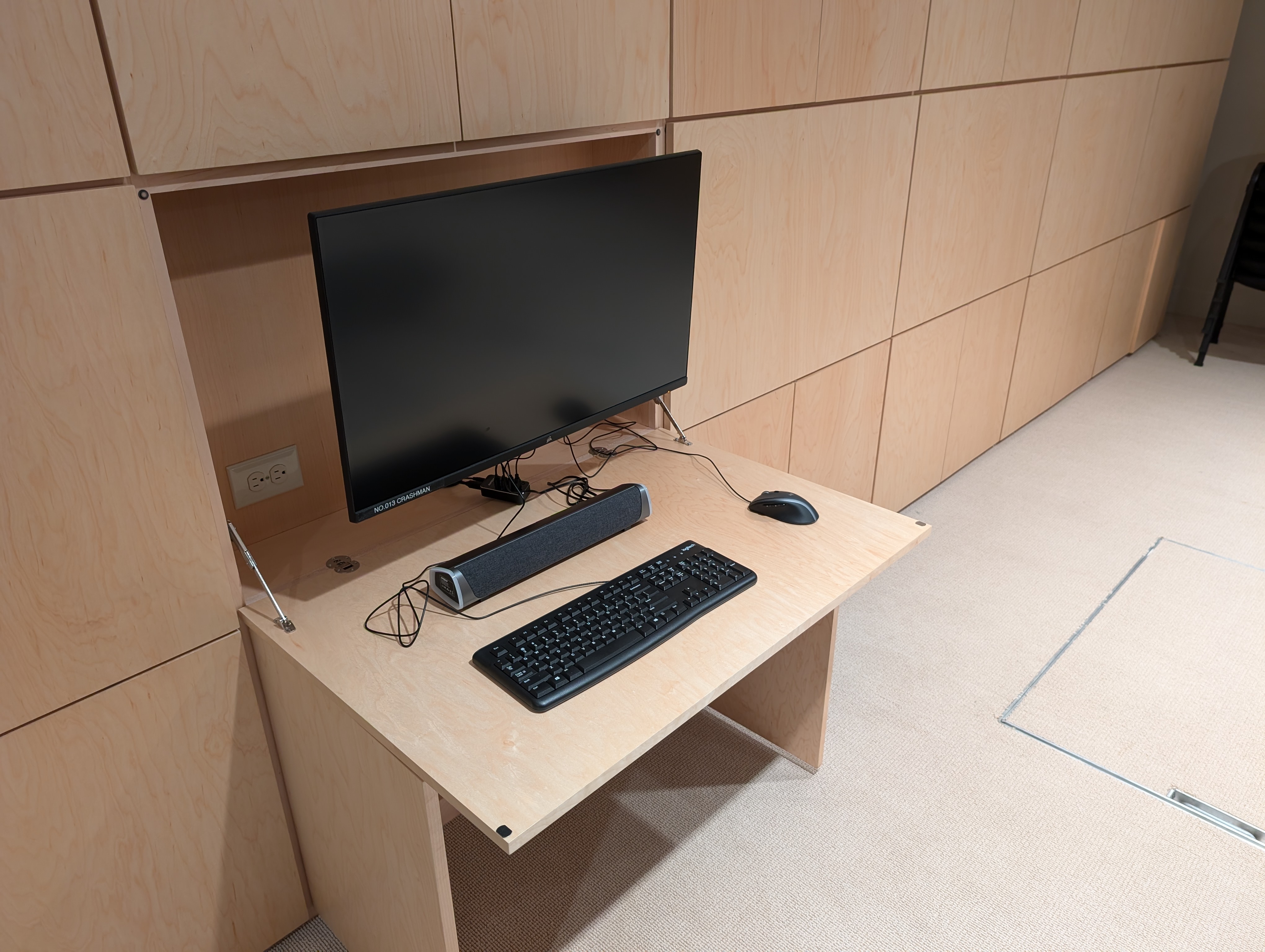 One of the LAN party house's 22 game stations, sitting on custom made, fold away wooden cabinetry.